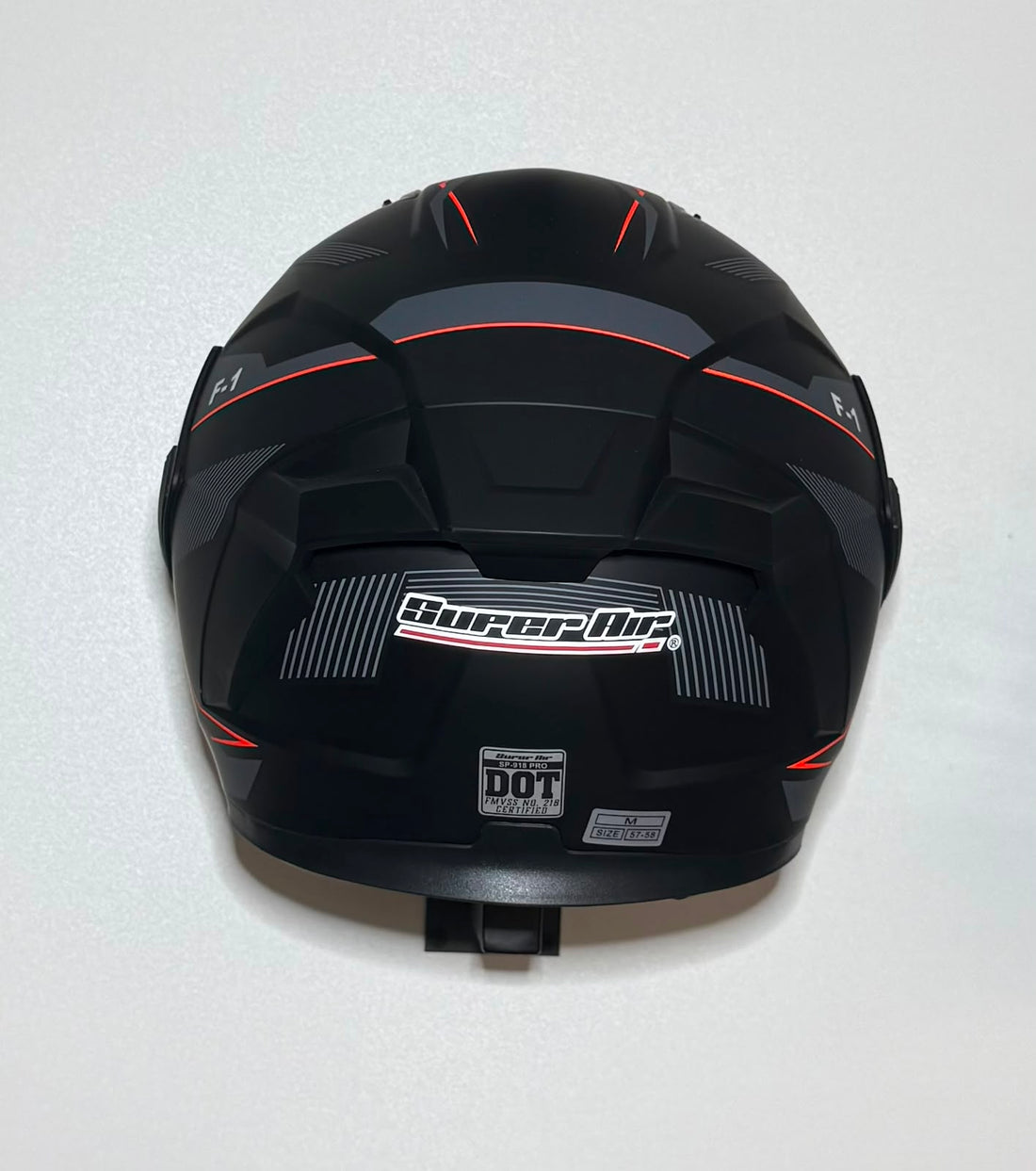 Super Air F-1 helmet side view with visor open showing gold iridium visor and F-1 badging on matte black shell